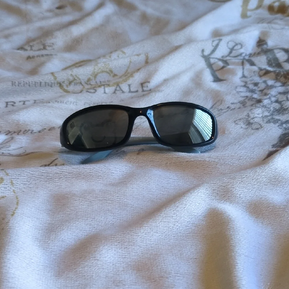 Black And Blue Baby Sunglasses With A Sleek Design Of A Frog On One Of The Lense